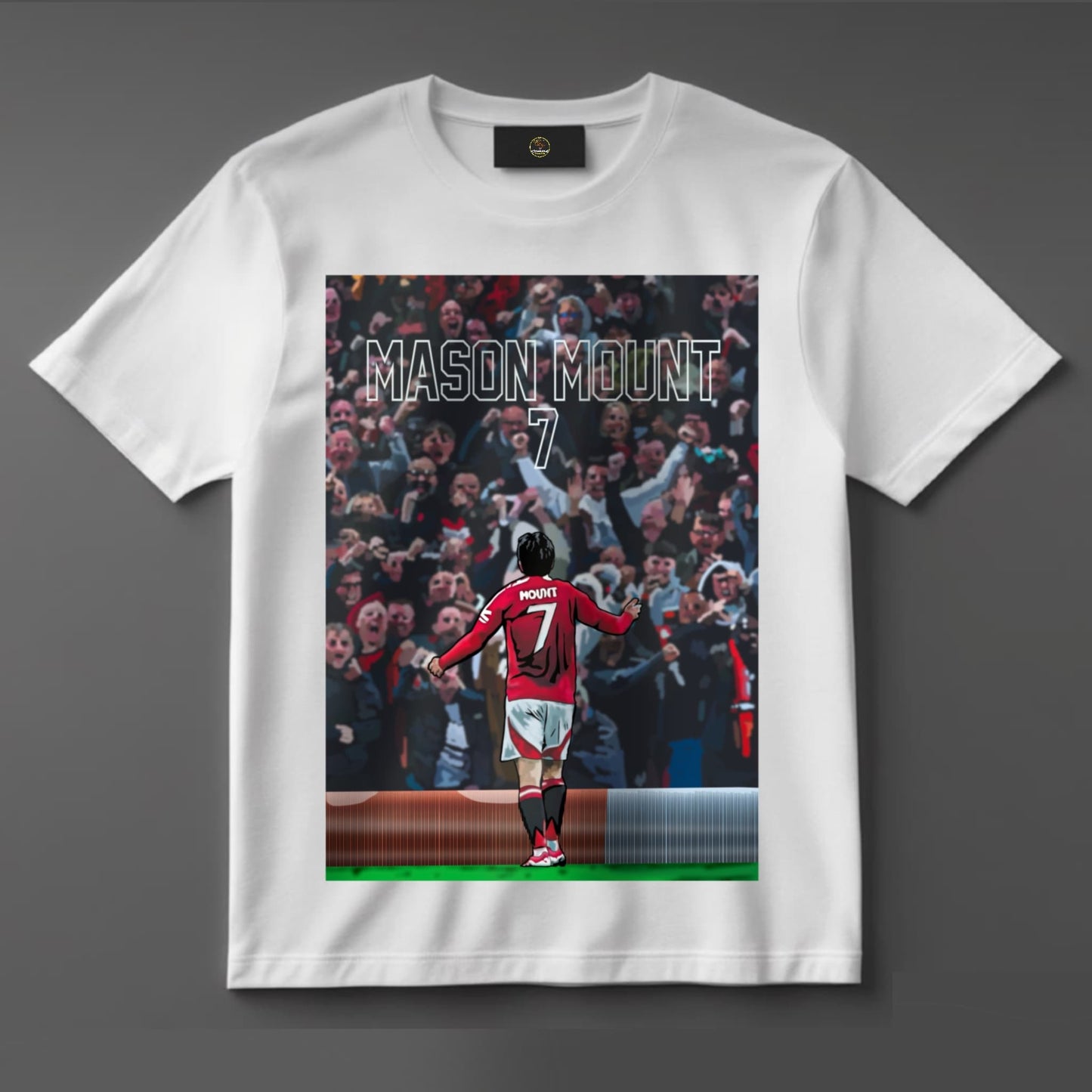 Black or white T-shirt featuring energetic artwork of Mason Mount celebrating in a Manchester United kit, capturing his passion and drive — a bold design for dedicated Red Devils supporters.