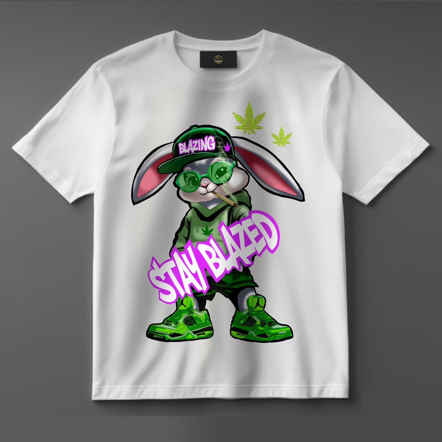 Black or white T-shirt featuring a laid-back cartoon rabbit with red eyes, puffing on a joint with smoke swirling around and the phrase ‘Stay Blazed’ — a fun, trippy design for cannabis lovers and stoner streetwear fans.