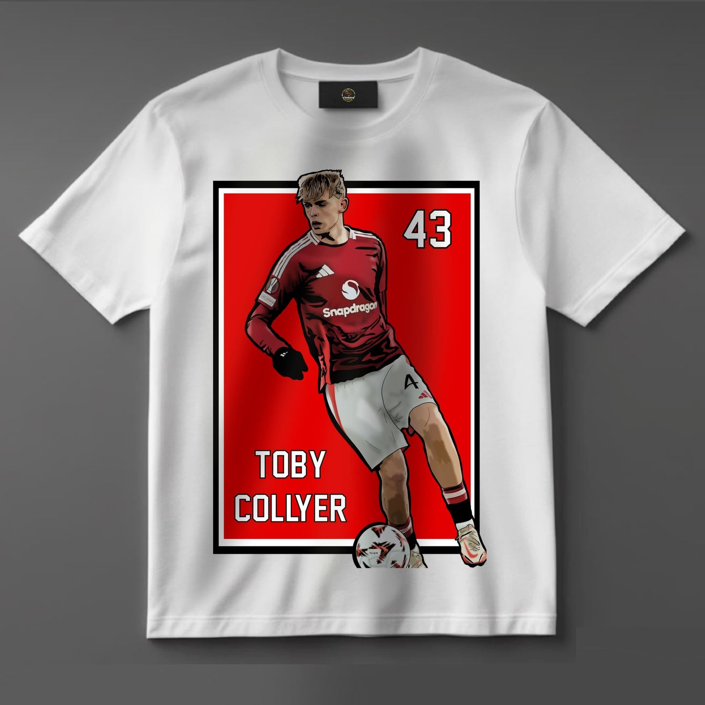 Black or white T-shirt showcasing graphic artwork of rising Manchester United talent Toby Collyer in action, wearing the iconic red kit — a fresh design for dedicated Man Utd fans and football collectors.
