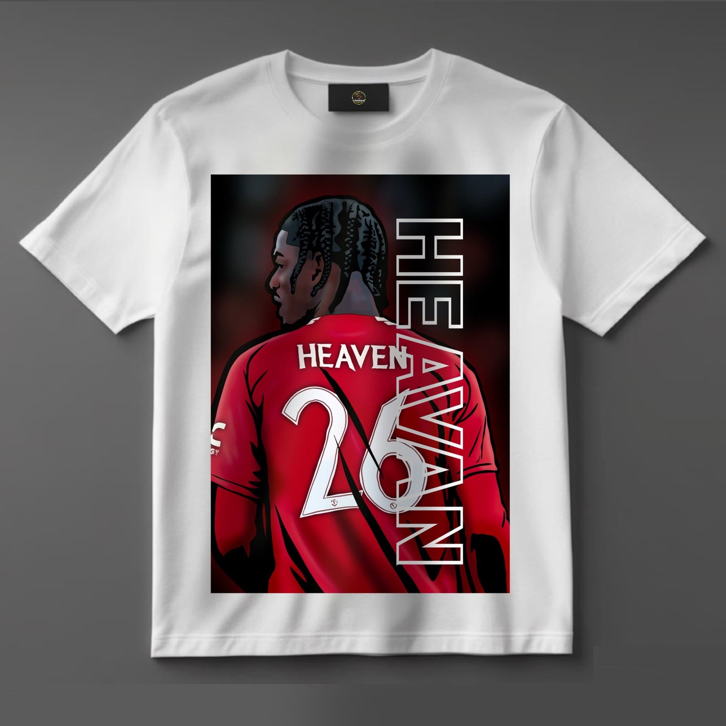 Black or white T-shirt featuring striking artwork of Ayden Heaven, the new Manchester United youth star, in the classic red kit — a fresh tribute to the next generation of Old Trafford talent.