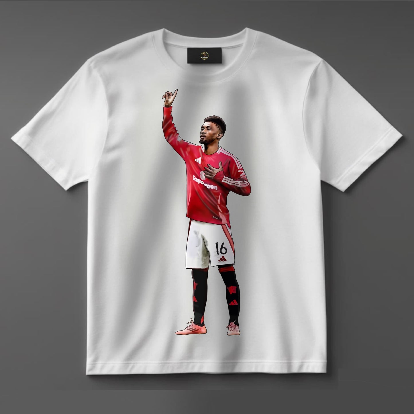 T-shirt showcasing dynamic graphic of Amad Diallo in a Manchester United kit, celebrating on the pitch — a must-have for true Man Utd supporters and football fans.